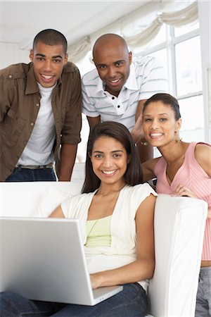 relaxing in couch black male - Group of People Using Laptop Computer Stock Photo - Premium Royalty-Free, Code: 600-01614137
