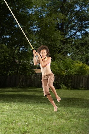 simsearch:600-01614284,k - Girl Swinging on Rope Outdoors Stock Photo - Premium Royalty-Free, Code: 600-01614228