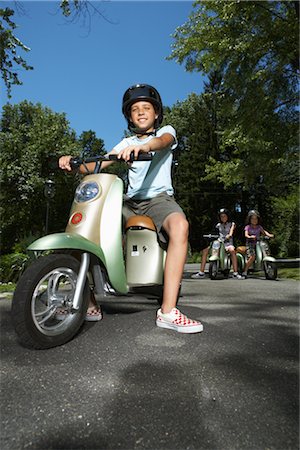 driveway low angle - Girl Riding Scooter Stock Photo - Premium Royalty-Free, Code: 600-01614241