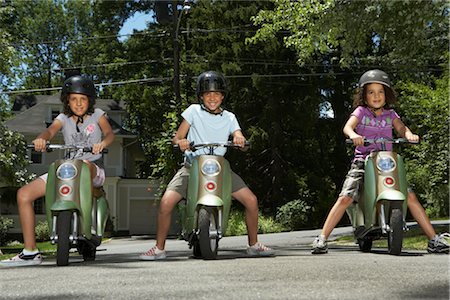 pictures of people riding scooters - Sisters Riding Scooters Stock Photo - Premium Royalty-Free, Code: 600-01614243
