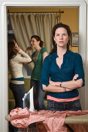 rolling eyes - Teenaged Girl Doing Housework While Friends Party Stock Photo - Premium Royalty-Free, Code: 600-01614601