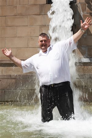 fat person arms up - Businessman in Fountain Stock Photo - Premium Royalty-Free, Code: 600-01614687