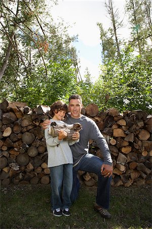 Father and Son with Chopped Wood Stock Photo - Premium Royalty-Free, Code: 600-01614768