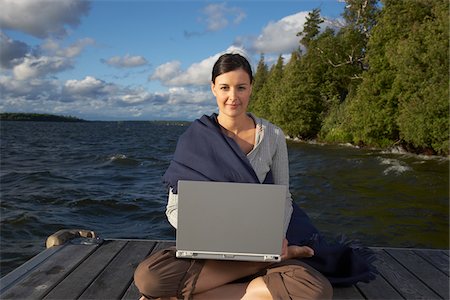 secluded lake woman - Woman Using Laptop on Dock Stock Photo - Premium Royalty-Free, Code: 600-01614824