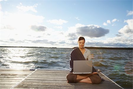 secluded lake woman - Woman Using Laptop on Dock Stock Photo - Premium Royalty-Free, Code: 600-01614827
