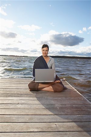 secluded lake woman - Woman Using Laptop on Dock Stock Photo - Premium Royalty-Free, Code: 600-01614828
