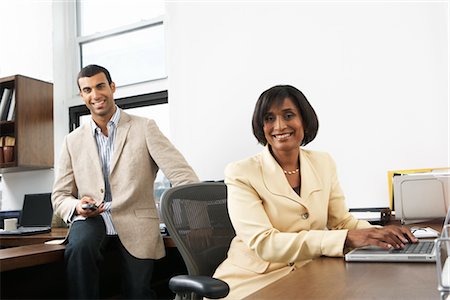 executive looking at camera on desk - Coworkers in Office Stock Photo - Premium Royalty-Free, Code: 600-01615008