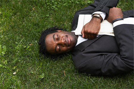 smile happy black ethnic - Businessman Lying in the Grass Stock Photo - Premium Royalty-Free, Code: 600-01615300