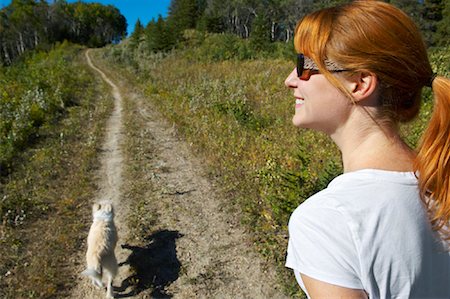 red haired woman with dog - Woman Hiking With Her Dog Stock Photo - Premium Royalty-Free, Code: 600-01616571