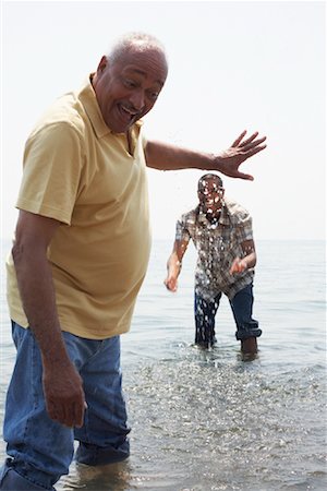 father son portrait old - Father and Son Playing in Water Stock Photo - Premium Royalty-Free, Code: 600-01616614