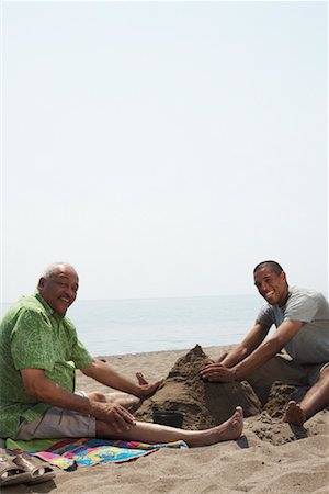 Father and Son Playing in Sand Stock Photo - Premium Royalty-Free, Code: 600-01616613