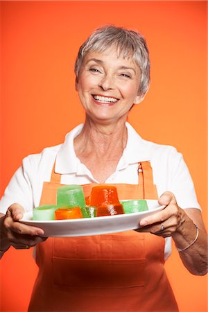 pictures of 54 year old women - Portrait of Woman Serving Food Stock Photo - Premium Royalty-Free, Code: 600-01613559