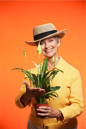 Portrait of Woman Holding Plant Stock Photo - Premium Royalty-Free, Code: 600-01613573