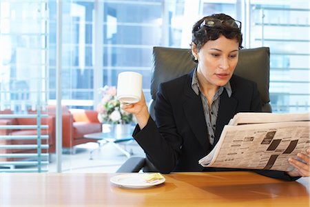 Businesswoman Reading Newspaper at Desk Foto de stock - Sin royalties Premium, Código: 600-01613749