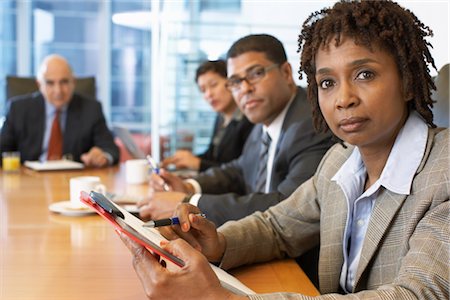 executive looking at camera on desk - Portrait of Business People Stock Photo - Premium Royalty-Free, Code: 600-01613778