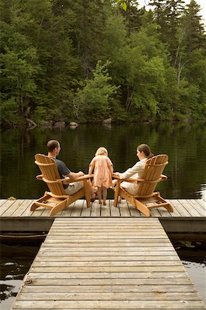 person sitting in adirondack chair - Family on Dock Stock Photo - Premium Royalty-Free, Code: 600-01639902