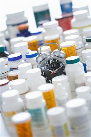 pill bottle in hand - Pill Bottles and Alarm Clock Stock Photo - Premium Royalty-Free, Code: 600-01630155