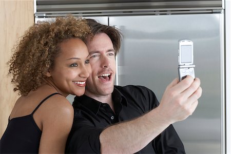 Couple Taking Pictures of Themselves With Camera Phone Stock Photo - Premium Royalty-Free, Code: 600-01632898