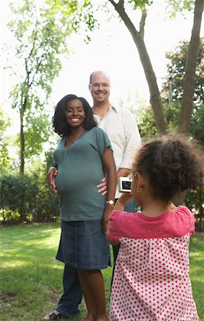 rear view african american girl - Girl Taking Picture of Parents Stock Photo - Premium Royalty-Free, Code: 600-01644688