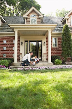 Father Tying Daughter's Shoe Stock Photo - Premium Royalty-Free, Code: 600-01644708