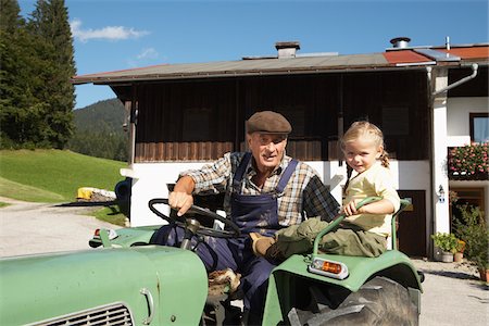 Farmer and Girl on Tractor Fotografie stock - Premium Royalty-Free, Codice: 600-01644968