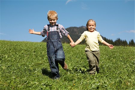 Brother and Sister Running Down Hill Stock Photo - Premium Royalty-Free, Code: 600-01644963