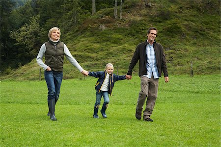 fashion men modeling outdoor - Family Walking in Field Stock Photo - Premium Royalty-Free, Code: 600-01645035