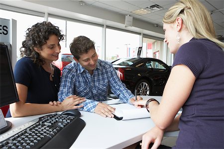 Couple With Car Saleswoman Stock Photo - Premium Royalty-Free, Code: 600-01645917