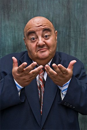 fat man facial expression - Businessman Shrugging Stock Photo - Premium Royalty-Free, Code: 600-01646048