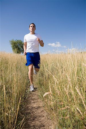 simsearch:600-01172446,k - Man Jogging in Field Foto de stock - Royalty Free Premium, Número: 600-01646329