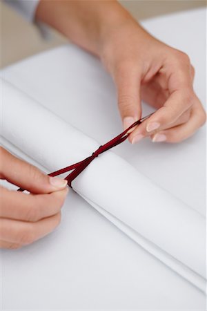 setting table and one person - Waitress Tying Napkin Stock Photo - Premium Royalty-Free, Code: 600-01646517