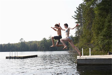 sport summer outside young caucasian adult not golf not surfing - Couple Jumping from Dock Stock Photo - Premium Royalty-Free, Code: 600-01670945