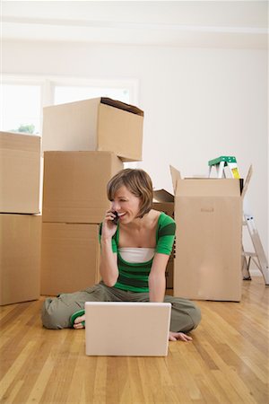 stack of phones - Woman Moving Into New Home Stock Photo - Premium Royalty-Free, Code: 600-01694088