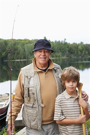 pictures of family fishing boats - Man and Boy by Lake with Fishing Gear Stock Photo - Premium Royalty-Free, Code: 600-01694154
