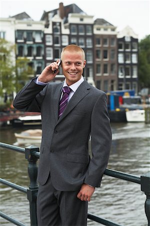 Businessman with Cellular Phone, Amsterdam, Netherlands Stock Photo - Premium Royalty-Free, Code: 600-01695088