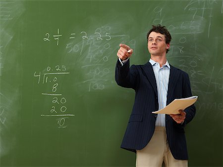 simsearch:6111-06727552,k - Teacher Standing in Front of Blackboard Foto de stock - Sin royalties Premium, Código: 600-01695349