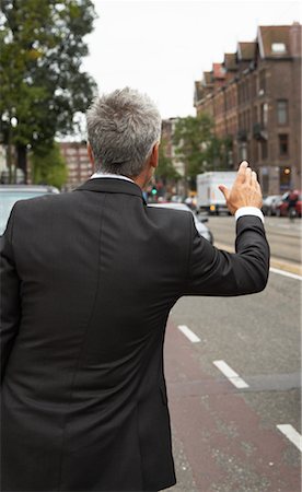 picture of someone hailing a taxi - Businessman Hailing Cab, Amsterdam, Netherlands Stock Photo - Premium Royalty-Free, Code: 600-01695555