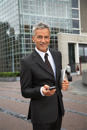 person with old mobile phone - Homme d'affaires avec organiseur électronique, Amsterdam, Pays-Bas Photographie de stock - Premium Libres de Droits, Code: 600-01695560