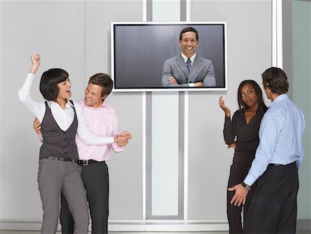 Business People Videoconferencing with Big Screen Television Fotografie stock - Premium Royalty-Free, Codice: 600-01695653