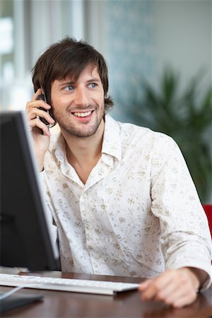 Man Using Computer and Cellular Phone Stock Photo - Premium Royalty-Free, Code: 600-01693962
