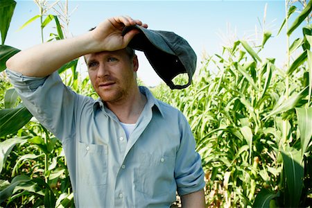field alone smiling young man outdoors - Farmer in Cornfield Stock Photo - Premium Royalty-Free, Code: 600-01715966