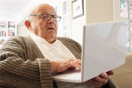 stressed old people - Senior Man Using Laptop Computer Stock Photo - Premium Royalty-Free, Code: 600-01716119