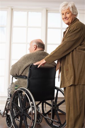 person in wheelchair at home - Senior Man Receiving Assistance with Wheelchair Foto de stock - Sin royalties Premium, Código: 600-01716130