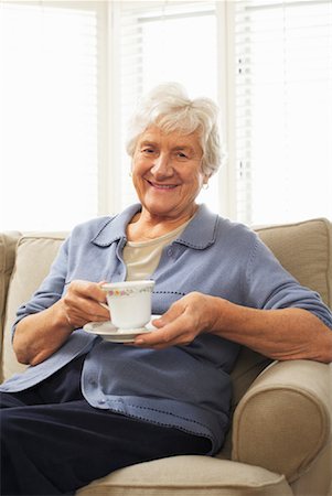 senior woman and drink and one person - Portrait of Senior Woman Sitting on Sofa Holding Cup and Saucer Stock Photo - Premium Royalty-Free, Code: 600-01716146