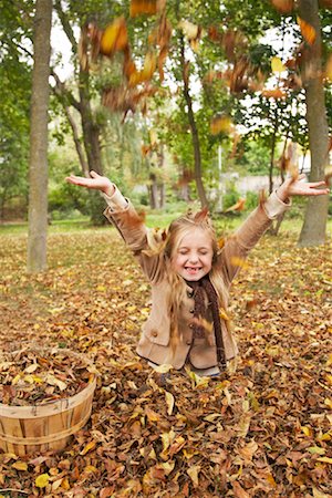 Girl Throwing Autumn Leaves in Air Stock Photo - Premium Royalty-Free, Code: 600-01717657