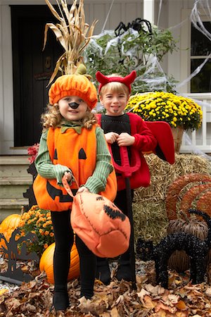 Portrait of Girl Dressed-up as Pumpkin and Boy Dressed-up as Devil Stock Photo - Premium Royalty-Free, Code: 600-01717682