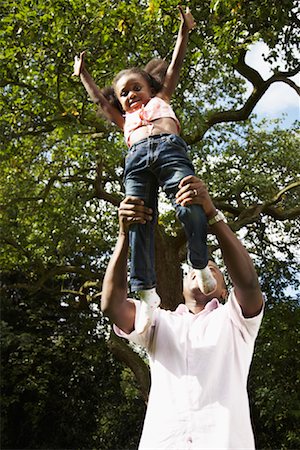 Man with Daughter in Backyard Stock Photo - Premium Royalty-Free, Code: 600-01717929