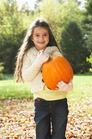 Girl Carrying Pumpkin Stock Photo - Premium Royalty-Free, Code: 600-01742498