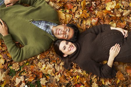 fall leaves on ground - Couple Lying in Autumn Leaves Stock Photo - Premium Royalty-Free, Code: 600-01742505