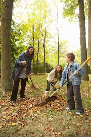 Grandmother and Grandchildren Raking Leaves Stock Photo - Premium Royalty-Free, Code: 600-01742517